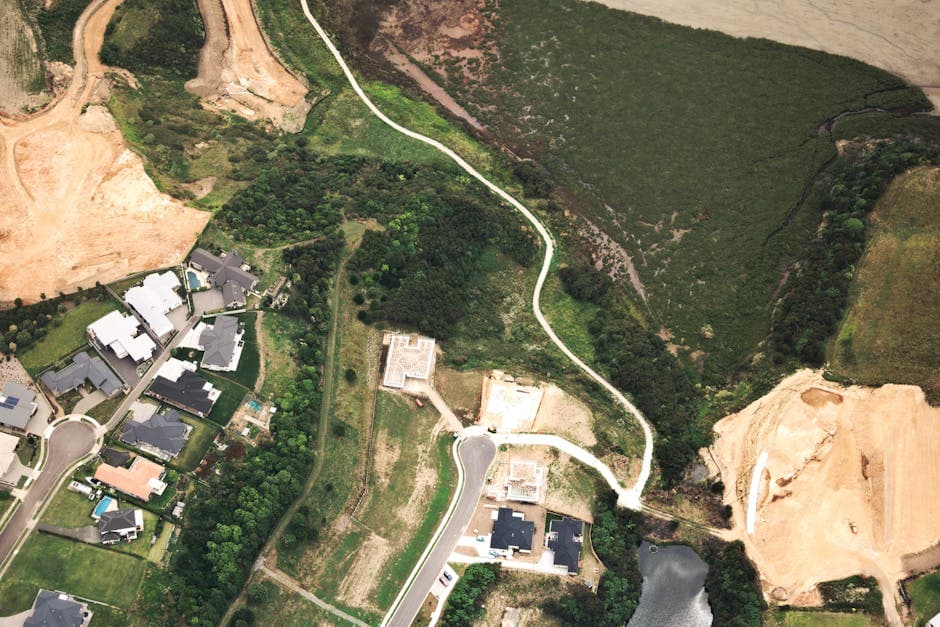 Aerial view of suburban housing development and green spaces